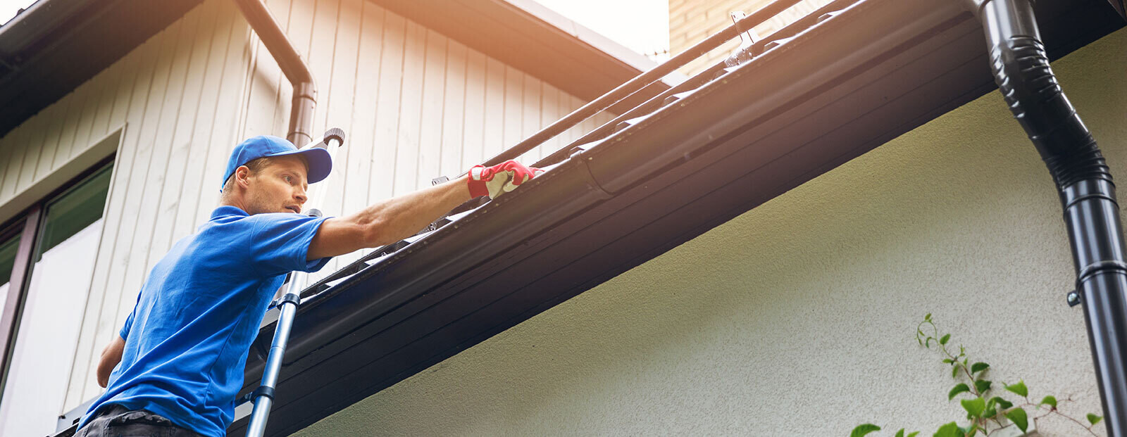 Man cleaning gutters